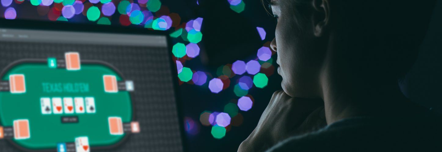 Woman playing online poker late at night